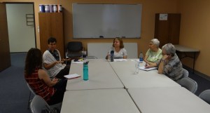 Kelly Carpenter at left corner of table